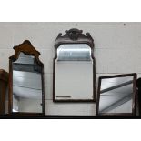 A Georgian style bevelled wall mirror in fret cut burr walnut frame surrounded by foliate roundel,