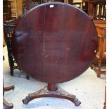 A Victorian mahogany circular tilt-top breakfast table on triform platform base to carved paw feet