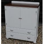 A pine top Dulux off-white painted two door cupboard over two long drawers, raised on bun feet, 92