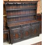 An antique oak high dresser, the three tier open rack over three moulded drawers over a trio of