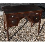 An Edwardian red walnut three drawer kneehole dressing table/desk, raised on square tapering legs,