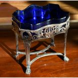 An Empire-style plated on copper bonbon dish with blue glass liner, the sides pierced with sphinxes,