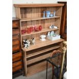 An antique pine open fronted dresser in two sections, 150 cm wide x 57 cm deep x 200 cm high