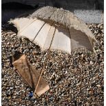 An antique silk and lace parasol, the varnished wood handle with cut glass finial