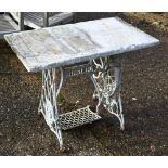 An antique cast iron Singer sewing table base, now with a rectangular male top