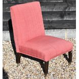 An Edwardian mahogany framed nursing chair in pastel red fabric upholstery