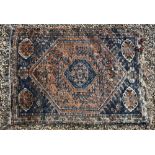 A Persian Shiraz blue/orange ground thick pile rug with geometric designs, 207 x 148 cm