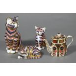 Three Royal Crown Derby china cat paperweights, 13-4 cm to/w a miniature teapot (4)