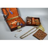 A brown leather jewel box containing a collection of jewellery and other items including agate