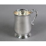 Silver baluster half-pint mug in the Georgian manner, with scroll handle and moulded foot-rim,