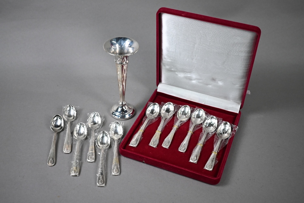 Twelve coffee spoons with shell finials and feather-edge stems, stamped 'Silver' - unused in case