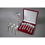 Twelve coffee spoons with shell finials and feather-edge stems, stamped 'Silver' - unused in case