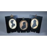 A pair of Victorian painted silhouette portraits, highlighted with gilt, and a husband and wife,