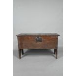 A 17th century oak five-plank coffer, the top with chip carved edges and iron plate repairs over
