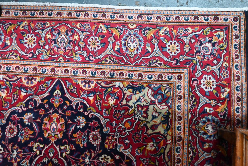 A contemporary central Persian Kashan carpet, the blue and red ground centred by a floral medallion, - Image 3 of 4