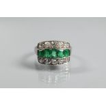 An emerald and diamond three row Art Deco style ring, the central row with five graduated baguette