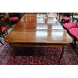 A George III mahogany dining table, the pair of d-ends with twin gate-legs united by two extension
