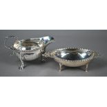 Early George III small silver sauce boat with gadrooned rim and scroll handle, on three hoof feet,