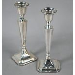 Pair of loaded silver baluster candlesticks in the Art Deco style, on moulded square bases with