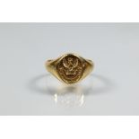An unmarked yellow metal signet ring with intaglio crest, size I, approx 2.7g