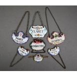 Collection of seven various antique enamel decanter labels