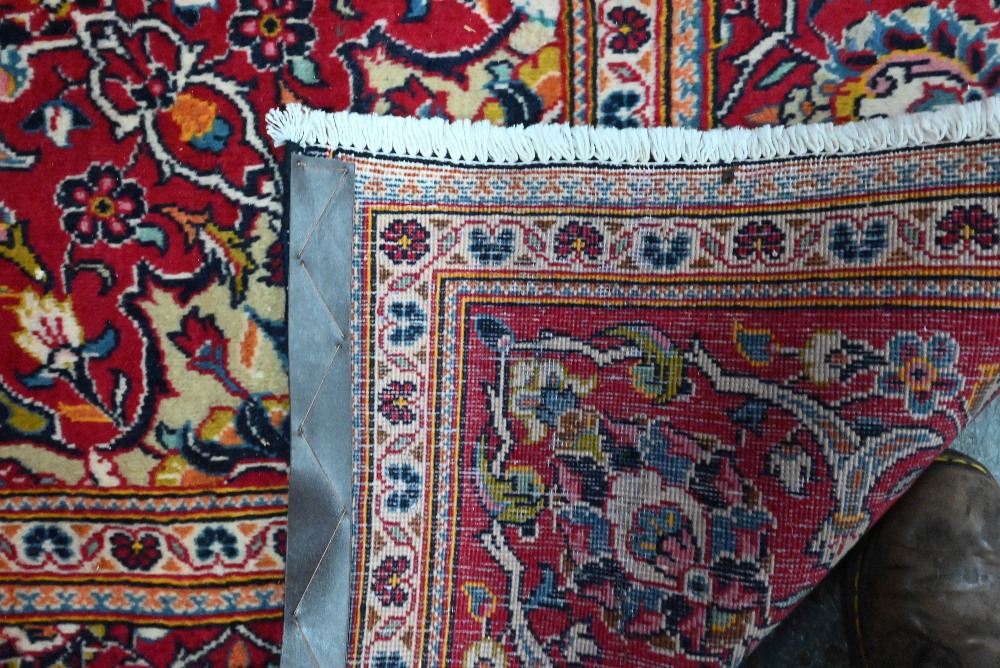 A contemporary central Persian Kashan carpet, the blue and red ground centred by a floral medallion, - Image 4 of 4