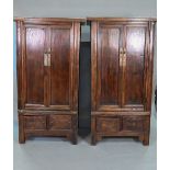 A companion pair of Chinese Northern elm (Yumu) cabinets, late Qing, two doors over two drawers,