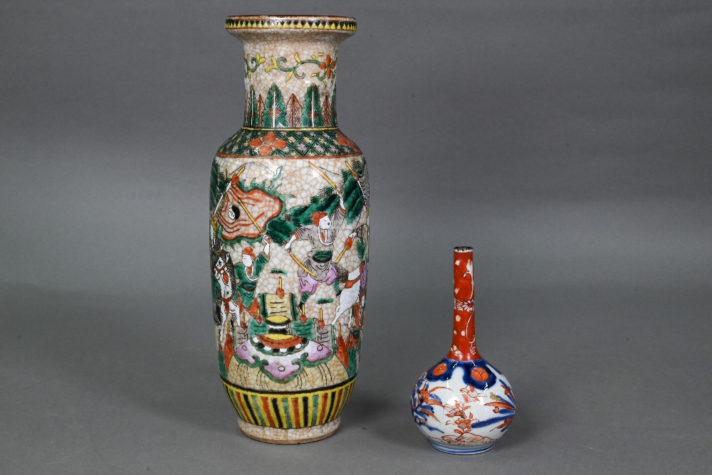 A late 19th or early 20th century Chinese famille rose rouleau vase, painted in polychrome enamels