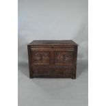 An antique oak mule chest, the two plank top over a twin carved panel and conforming drawer, 90 cm w