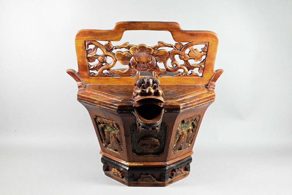 A Chinese stained hardwood water bucket of tapering octagonal form with floral and foliate fret-