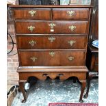 An 18th century and later oak and walnut chest on stand, two short over three long graduated drawers