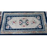 An antique Chinese Peking rug, first quarter 20th century, the camel ground with scattered blue