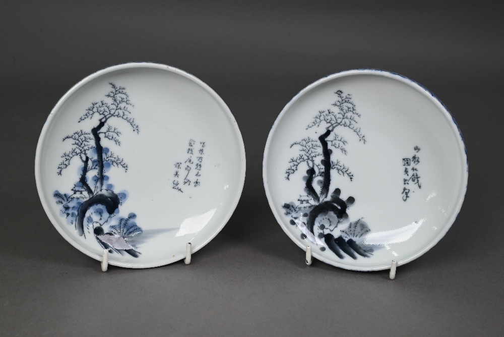 A pair of Japanese Arita blue and white bowls, Taisho/Showa period, the interiors painted in