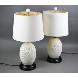 A pair of reticulated Chinese blanc de chine style table lamps by Orchid, with twin illumination and