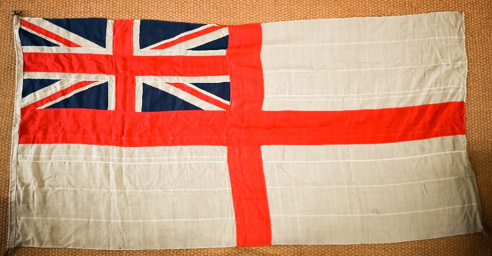 A WWII period Royal Navy ensign, of stitched panels with 'union jack' to top corner, stencilled 'C