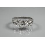 A seven stone diamond ring set 18ct white gold, the graduated marquise shaped diamonds in high