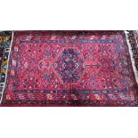 An old Persian Bidjar rug, the red ground centred by a mid-blue ground medallion, 2nd half 20th