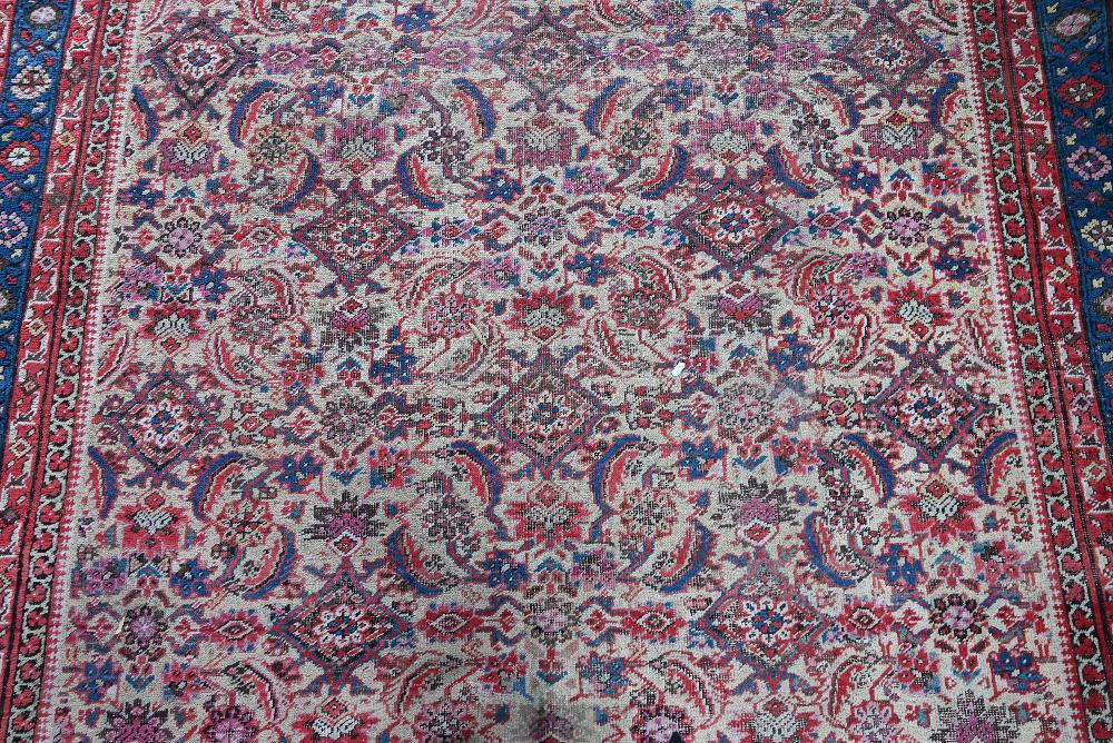 An antique Persian Bakhshayesh carpet, the geometric all-over repeat design on camel ground, 530 - Image 3 of 5
