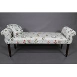 An upholstered Victorian style twin scroll end window seat on turned legs with floral and bird