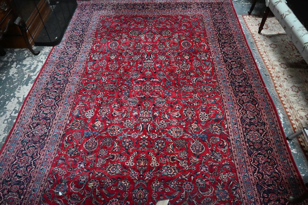 A fine old Persian hand-made Kashan carpet, the red ground with repeating linked garden vine design,