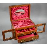 A late Victorian walnut jewellery box, the domed hinge lid enclosing a fitted interior, over a