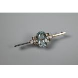 An Art Deco style bar brooch, the central oval pale blue paste in rectangular setting with two round