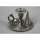 George IV silver chamber taper-stick with gadrooned rims and shell-mounted ring handle, c/w original