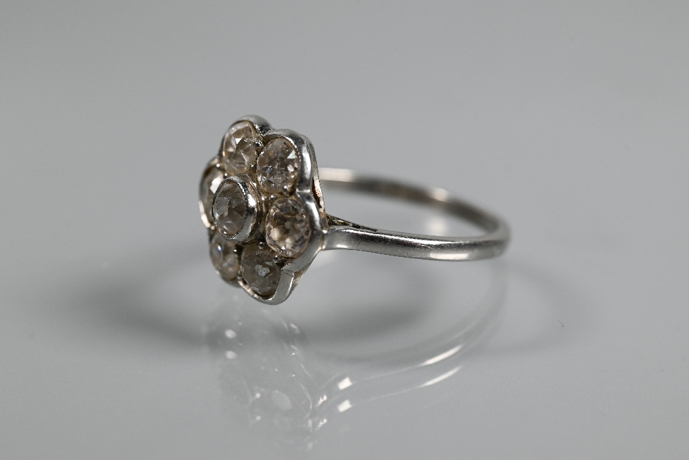 An antique diamond daisy cluster ring, the millgrain set central old cut diamond surrounded by six - Image 3 of 4