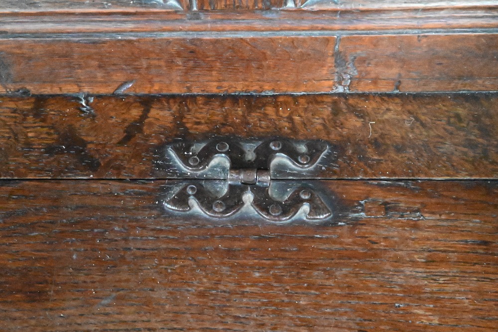 An antique oak box settle, the panelled back with floral carved rosette's over shaped arms and an - Image 5 of 6