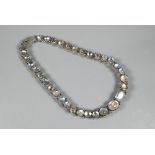 An Arts & Crafts style choker necklace set with thirty-three graduated cabochon moonstones, in