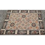 A classic Aubusson style needlepoint rug, the floral design on ochre ground, 236 cm x 180 cm