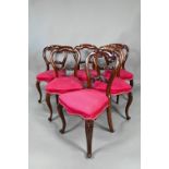 A set of twelve Victorian mahogany style dining side chairs, with overstuffed crimson silk seats,