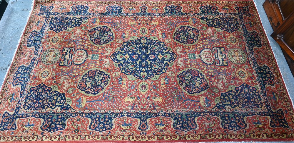 A good fine antique Persian Kashan rug, the rust-red ground centred by a blue ground medallion,