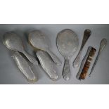 Silver toilet set with engraved decoration, comprising hand-mirror, two pairs of brushes, shoehorn